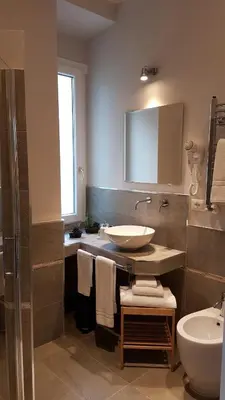 a bathroom with a sink and a toilet at Roman Suite Guest House in Rome