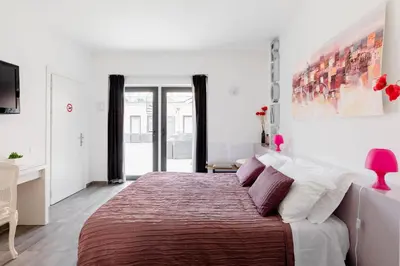 a bedroom with a large bed with a red blanket at Rhome Accomodation in Rome