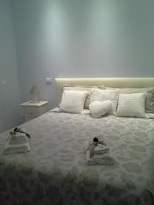 a bedroom with two dolls laying on a bed at La Cupola Suite in Rome