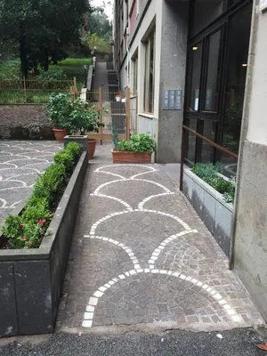 a walkway with a design on the side of a building at La Cupola Suite in Rome