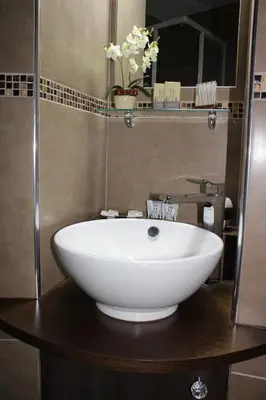 a bathroom with a white sink and a mirror at La Cupola Suite in Rome
