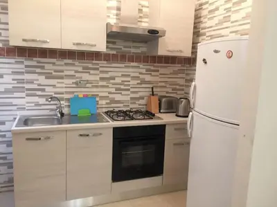 a kitchen with a white refrigerator and a stove at Lorenzo Magnifico Apartment in Rome