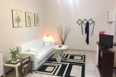 a living room with a white couch and a table at Lorenzo Magnifico Apartment in Rome