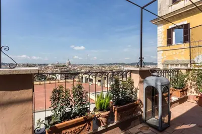 a balcony with potted plants and a view of a city at My Spanishsteps in Rome