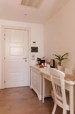 a white kitchen with a white desk and a white door at My Spanishsteps in Rome