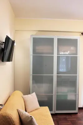 a large glass cabinet in a living room with a couch at Arcadia Domus in Rome