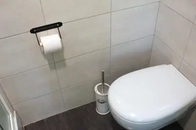 a bathroom with a toilet and a roll of toilet paper at Arcadia Domus in Rome