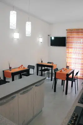 a dining room with tables and chairs and a tv at Arcadia Domus in Rome