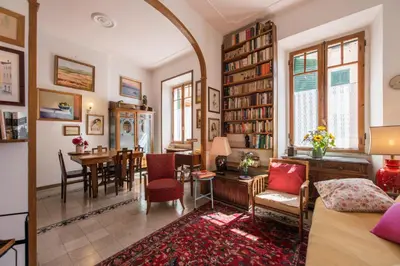 a living room with a table and a dining room at Colosseo Holiday House in Rome