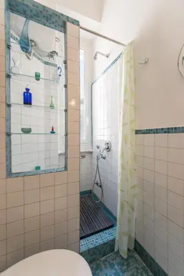a bathroom with a shower and a toilet at Colosseo Holiday House in Rome
