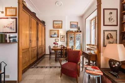 a living room with a table and a chair at Colosseo Holiday House in Rome