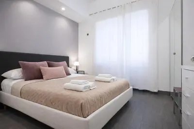 a bedroom with a large bed with two towels on it at Saint Peter Basilica 200m- 2BR -2BA -Sleeps 6 in Rome