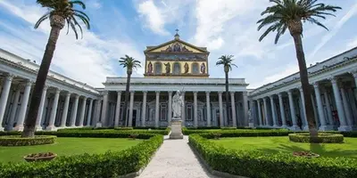 a large building with palm trees and a clock tower at Villino Marcella in Rome