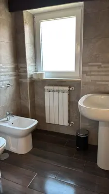 a bathroom with a sink and a toilet and a window at Casa Trasteverina in Rome