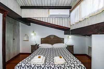 a bedroom with a large bed with two levels at Casa Trasteverina in Rome