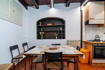 a dining room with a table and chairs at Casa Trasteverina in Rome
