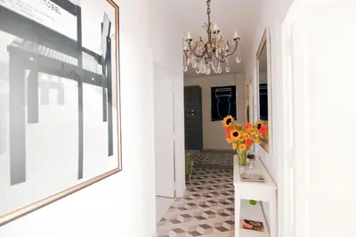 a hallway with a vase of flowers on a table at Mio House Vatican in Rome