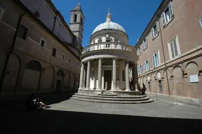 a building with a dome in the middle of a street at HISTORICAL CENTER ROME NAVONA AC 2 ROOMS HOLY DOOR VATICAN 5 MINUTES ON WALk in Rome