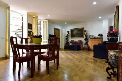 a living room with a table and chairs and a couch at Elite Rome Apartments in Rome