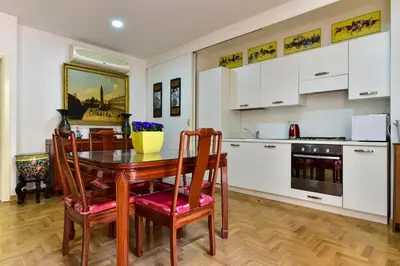 a kitchen and dining room with a table and chairs at Elite Rome Apartments in Rome