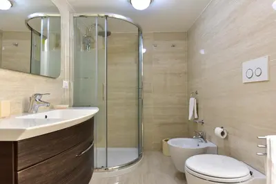 a bathroom with a shower and a toilet and a sink at Elite Rome Apartments in Rome