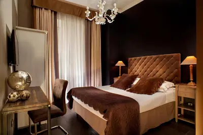a bedroom with a large bed and a table and a chair at The B Place in Rome