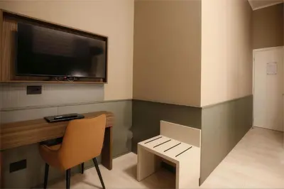 a room with a desk and a tv and a chair at The B Place in Rome