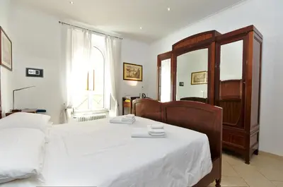 a bedroom with two beds and a mirror at Roma Borgo91 in Rome