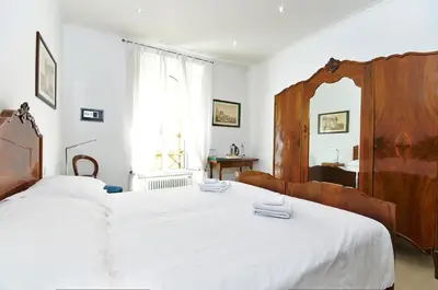 a bedroom with a large white bed and a mirror at Roma Borgo91 in Rome