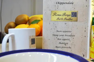 a table with a cup and a plate of fruit at Roma Borgo91 in Rome