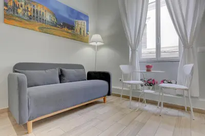 a living room with a couch and two chairs at Appartamento Santi Quattro - Colosseo in Rome