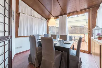 a dining room with a table and chairs at Vatican Luxury Terrace in Rome
