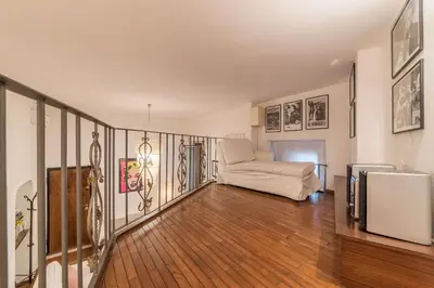 a living room with a chair and a television at Vatican Luxury Terrace in Rome