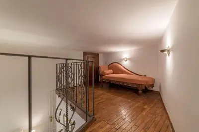 a living room with a bench and a stairway at Vatican Luxury Terrace in Rome