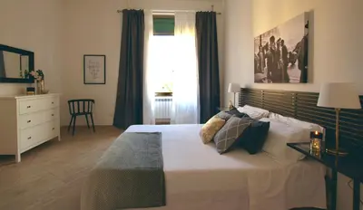 a bedroom with a large bed and a window at Domus in Laterano in Rome