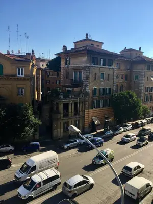 a street with cars parked in a parking lot with buildings at Domus in Laterano in Rome