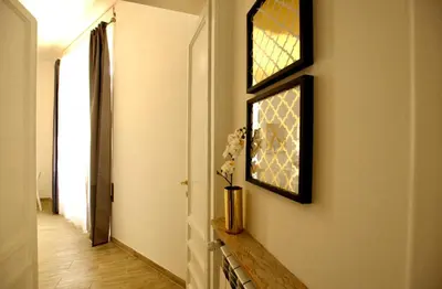 a hallway with a window and a vase with flowers at Domus in Laterano in Rome