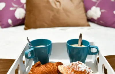a tray with two cups of coffee and some pastries at Saint Peter House Germanico in Rome