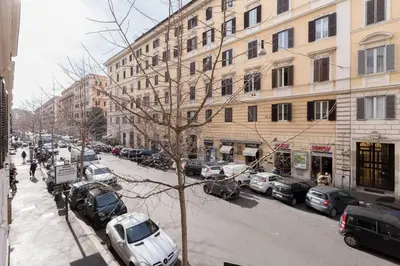 a city street with cars parked on the side of a building at Saint Peter House Germanico in Rome