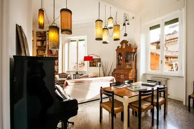 a living room with a table and a piano at Wanderlust - FromHometoRome in Rome