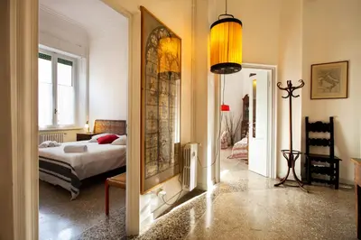 a bedroom with a bed and a large mirror at Wanderlust - FromHometoRome in Rome