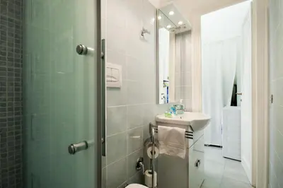 a bathroom with a shower and a sink at Wanderlust - FromHometoRome in Rome