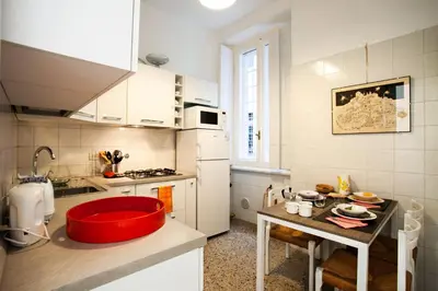 a kitchen with a red bowl on a table in it at Wanderlust - FromHometoRome in Rome