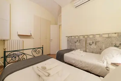 a bedroom with two beds with towels on them at Casa Cornacchie - FromHometoRome in Rome