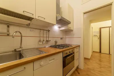 a kitchen with a sink and a stove at Casa Cornacchie - FromHometoRome in Rome