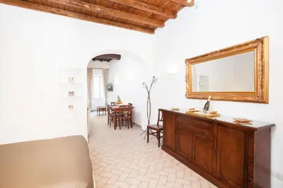 a living room with a mirror and a table at Tritone 91 Apartments in Rome