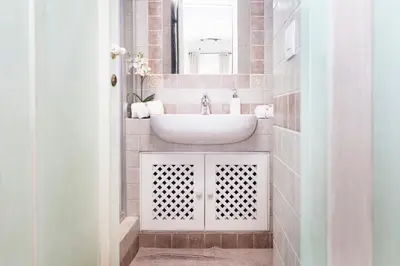 a bathroom with a sink and a mirror at Tritone 91 Apartments in Rome