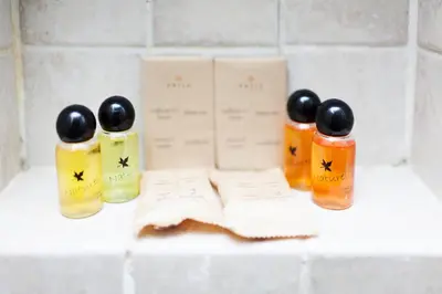 a group of three bottles of oils on a counter at Tritone 91 Apartments in Rome