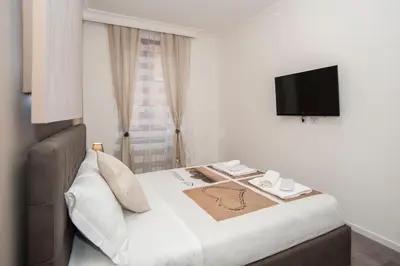 a hotel room with a bed and a television at Magia in Trastevere in Rome