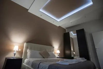 a bedroom with a bed with a skylight and a mirror at Magia in Trastevere in Rome